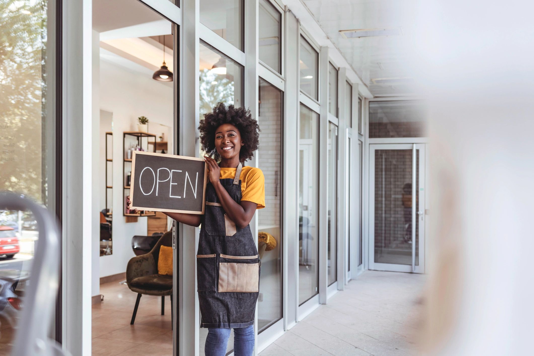 Retail store owner holding an open sign