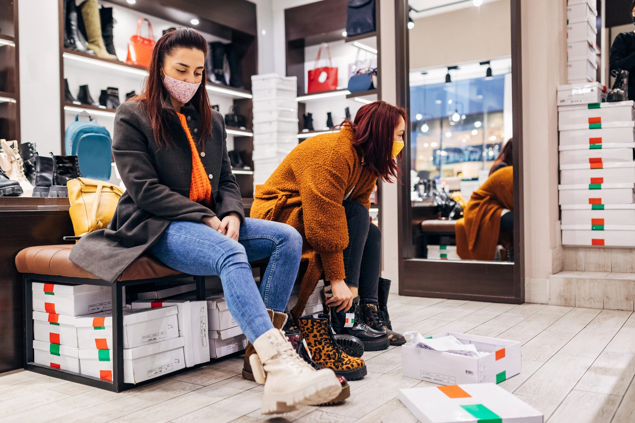 Customers trying on footwear in a retail store