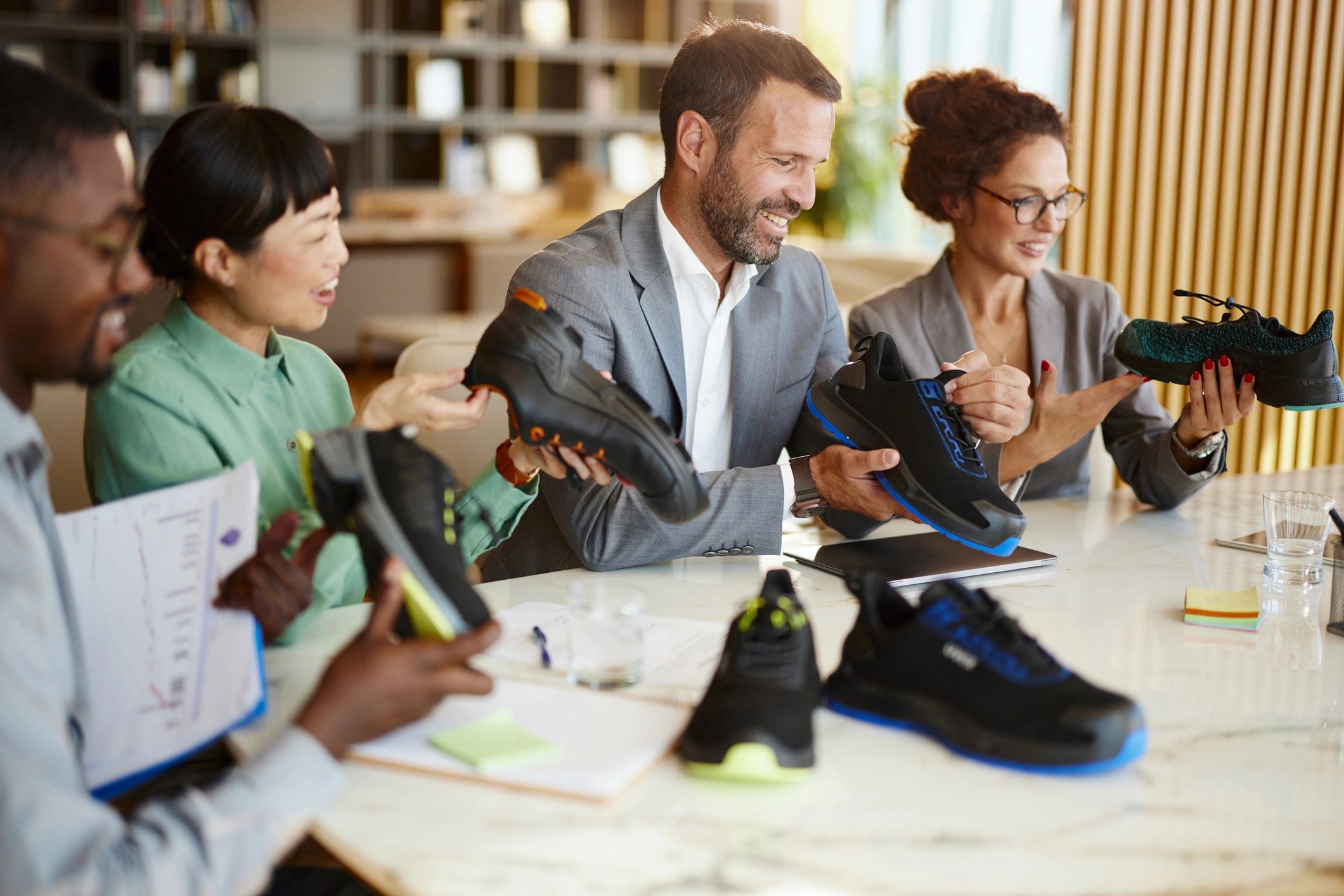 Team reviewing sneakers representing centralized brand control