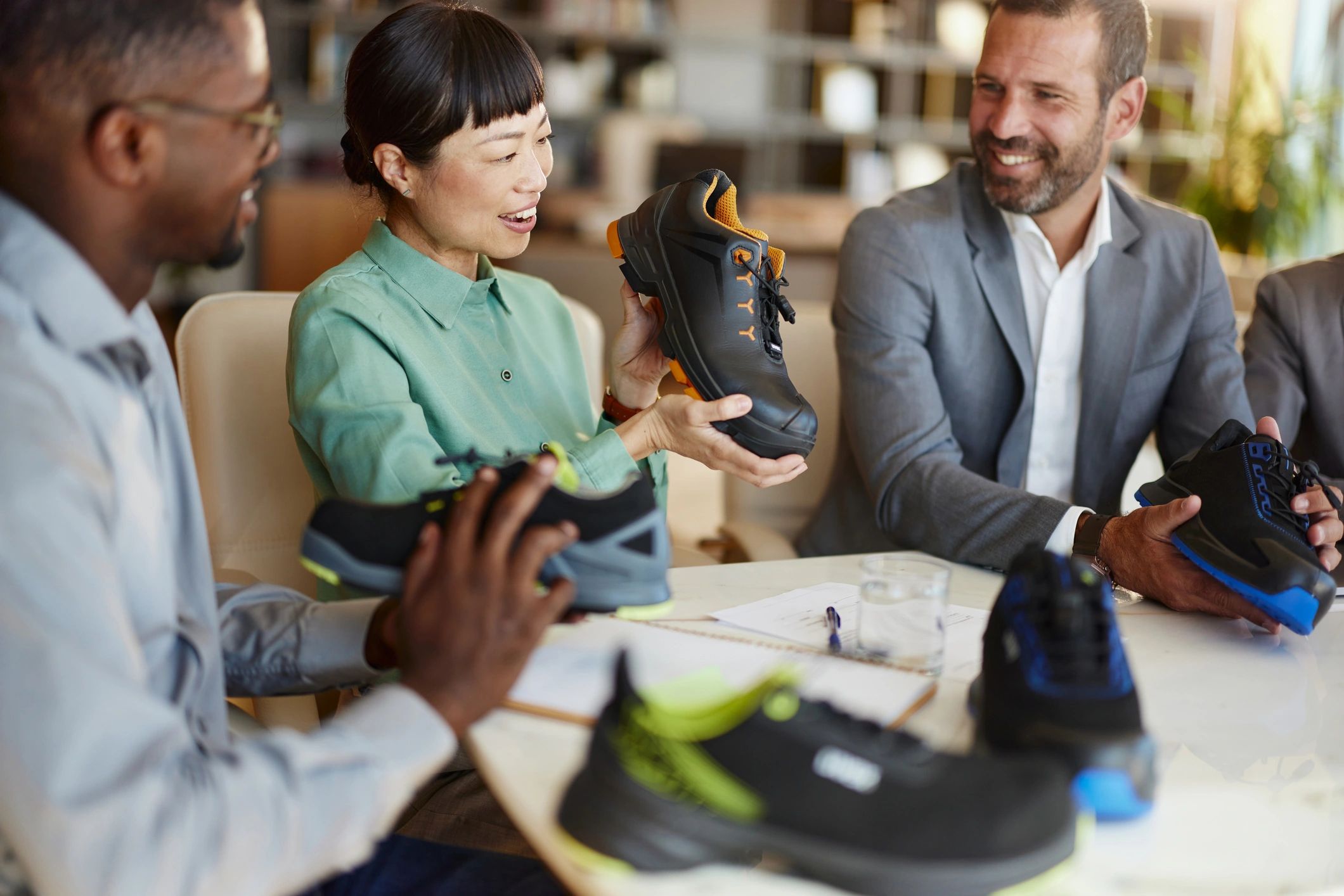 Entrepreneurs examining sneakers in an office