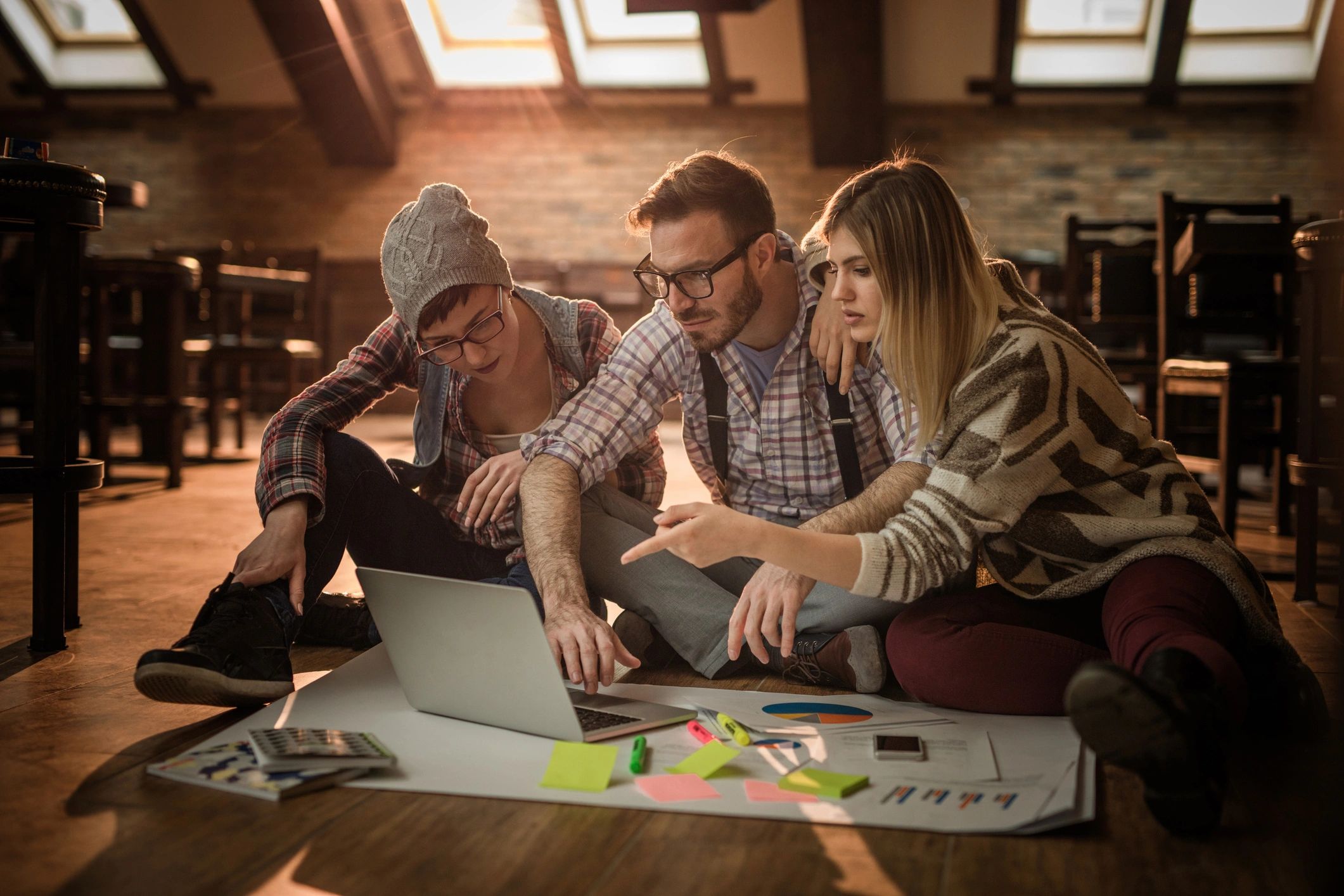 Marketing team planning social media content on a laptop